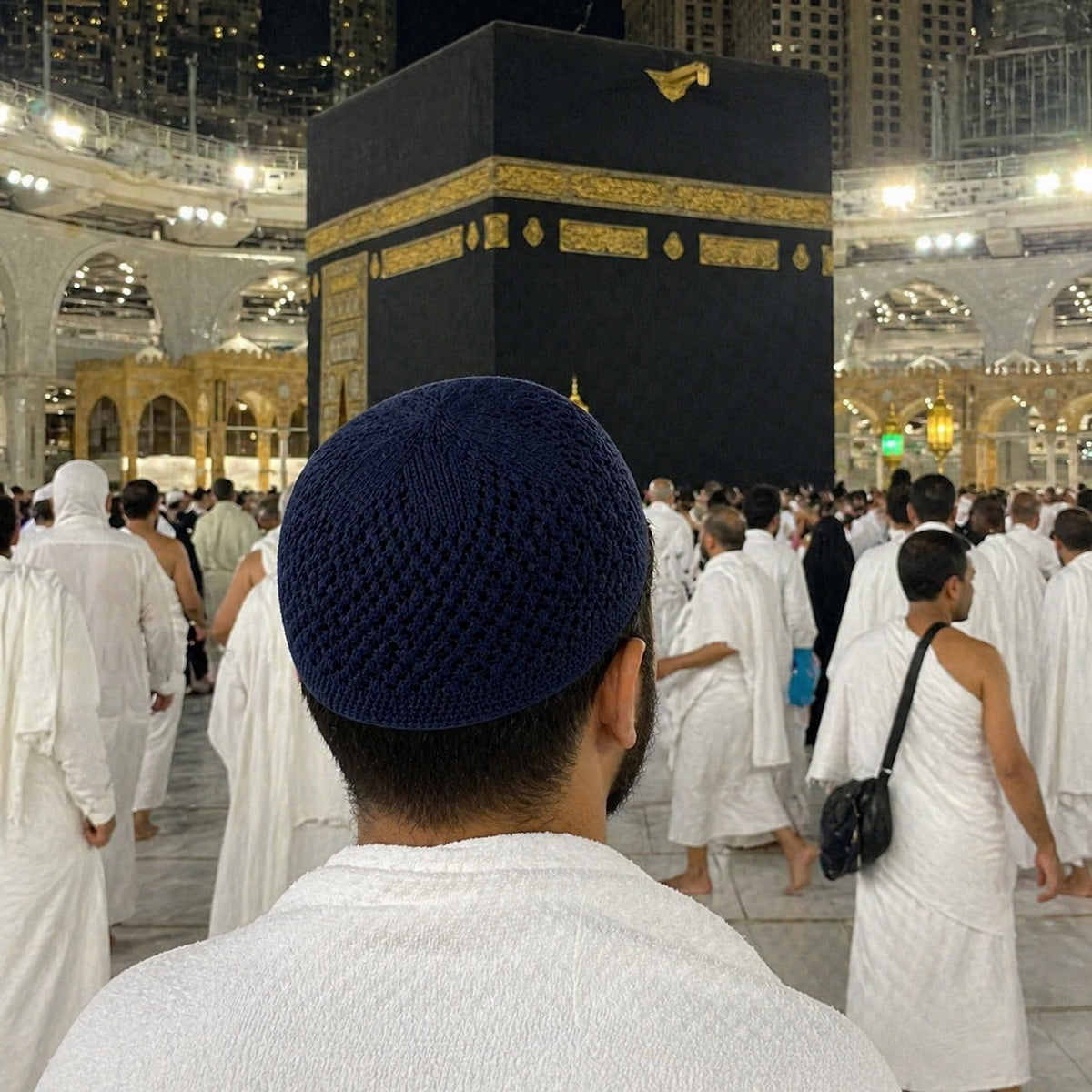 Dark blue knit kufi worn during Umrah at the Kaaba