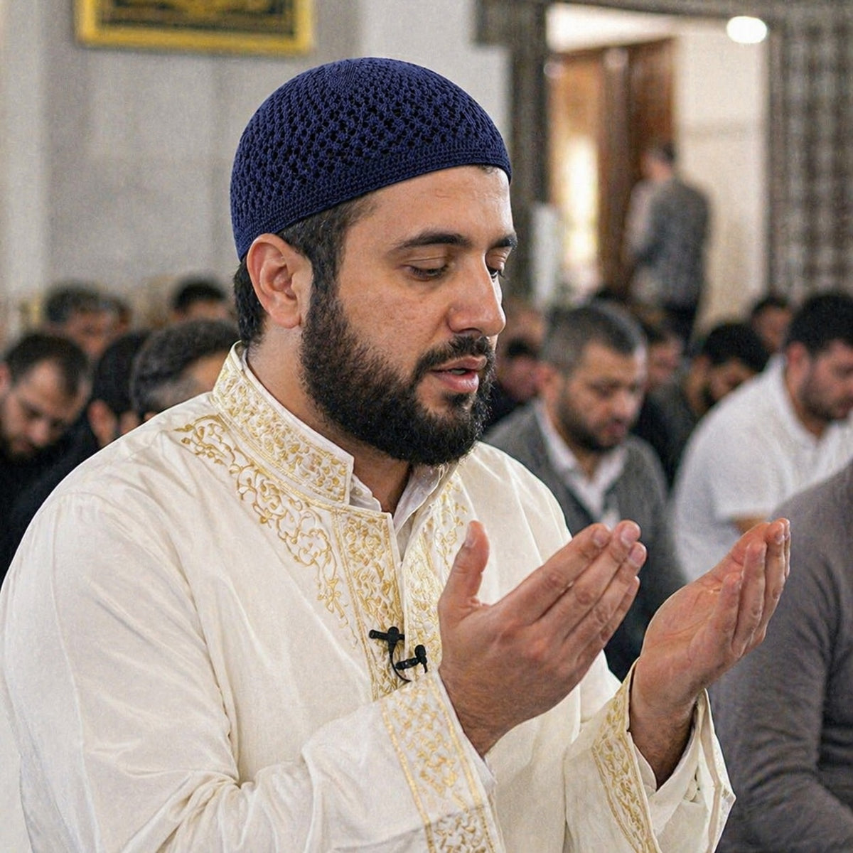 Man wearing dark blue knit kufi during prayer